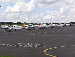 Piper Cherokees of the British Airways flying club at Booker Airfield, the United Kingdom. Booker-piperlineup.JPG