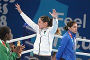 Deutsch: Boxen bei den Olympischen Jugendspielen 2018 Tag 12, 18. Oktober 2018 - Medaillenzeremonie im Fliegengewicht der Mädchen - Gold: Martina La Piana (Italien), Silber: Adijat Gbadamosi (Nigeria), Bronze: Heaven Destiny Garcia (USA); Medaillenübergabe durch Habu Gumel (IOC, Nigeria), Geschenkübergabe durch Dr. Joseph O. Ayeni (Nigeria, AIBA). English: Boxing at the 2018 Summer Youth Olympics on 18 October 2018 – Girl's flyweight Medal Ceremony - Gold: Martina La Piana (Italy), Silver: Adijat Gbadamosi (Nigeria), Bronze: Heaven Destiny Garcia (USA); Medal handover by Habu Gumel (IOC, Nigeria), Gift presented by Dr. Joseph O. Ayeni (Nigeria, AIBA). Español: Boxeo en los Juegos Olímpicos Juveniles de Verano de 2018 en 18 de octubre de 2018 - Ceremonia de la Medalla de peso mosca para niñas - Oro: Martina La Piana (Italia), Plata: Adijat Gbadamosi (Nigeria), Bronce: Heaven Destiny Garcia (Estados Unidos); Entrega de medallas por Habu Gumel (COI, Nigeria), Regalo presentado por Joseph O. Ayeni (Nigeria, AIBA).