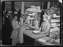 Marines from the 51st Defense Battalion get gear issued in March 1943. Camp Lejeune, New River, North Carolina. Scene and activities on camp grounds of the 51st Composite Battalion, U.S. Marine Corps, March, 1943. (49747695216).jpg