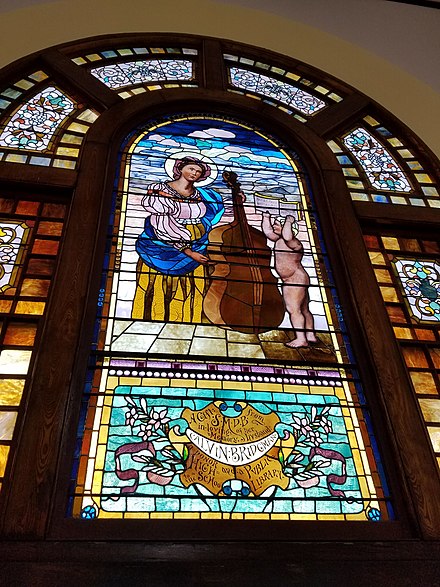 Clapp Memorial Library north window depicting Saint Cecilia, patroness of music. It is thought to have been fabricated by H.E. Hartwell, a New York decorator and designer, and was presented to the library by Susan Bridgman, one of the original library trustees. Clapp Memorial Library north window.jpg