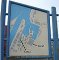 Sign showing buildings in the fjord harbour area with arrows added to point to the Dora complexes.