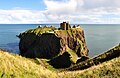 Image 2Dunnottar Castle (Scottish Gaelic: Dùn Fhoithear, meaning "fort on the shelving slope") is a ruined medieval fortress located upon a rocky headland on the north-east coast of Scotland, about two miles (3 km) south of Stonehaven. The surviving buildings are largely of the 15th–16th centuries, but the site is believed to have been an early fortress of the Dark Ages.