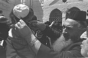 A rabbi performs the traditional first haircut on a three-year-old boy in Meron on Lag Baomer 1970. Flickr - Government Press Office (GPO) - First Haircut.jpg