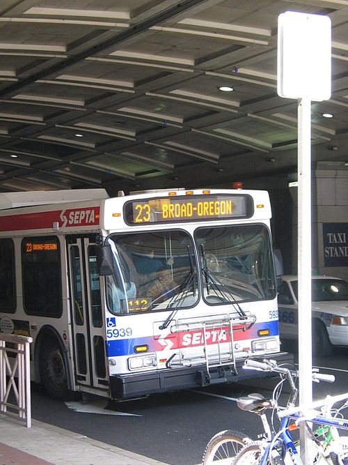 A New Flyer D40LF Route 23 bus passing under the Pennsylvania Convention Center arcade in 2006