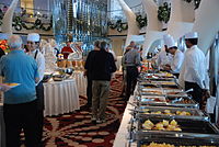Staffed hot buffet line aboard the Celebrity Equinox cruise ship