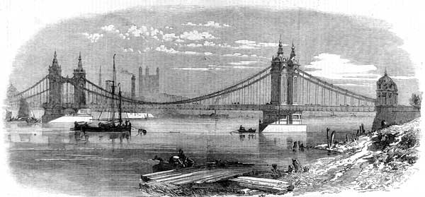 The first Chelsea Bridge as seen from Battersea in 1858, shortly after opening. The Victoria Tower of the Palace of Westminster is shown under constru