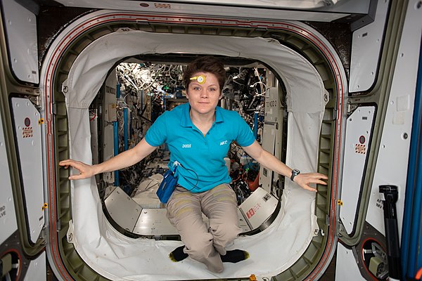 McClain inside the vestibule between the Harmony and Destiny modules, wearing a sensor on her forehead collecting data on how the circadian rhythm is 