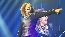 Jackson singing "Love Will Never Do (Without You)" during her 2015-16 Unbreakable World Tour. The song became the final of seven top five singles released from Rhythm Nation 1814. JanetJacksonUnbreak 1793 (23156373262).jpg