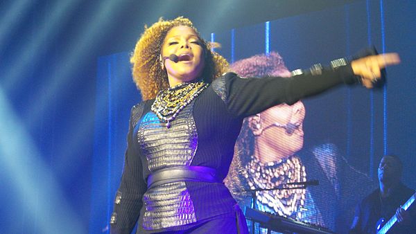 Jackson singing "Love Will Never Do (Without You)" during her 2015–16 Unbreakable World Tour. The song became the final of seven top five singles rele