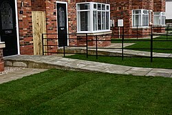 A photograph of access ramps to semi-detached houses of the 'Malet Close' development on the corner of James Reckitt Avenue and Clifford Street in Kingston upon Hull.