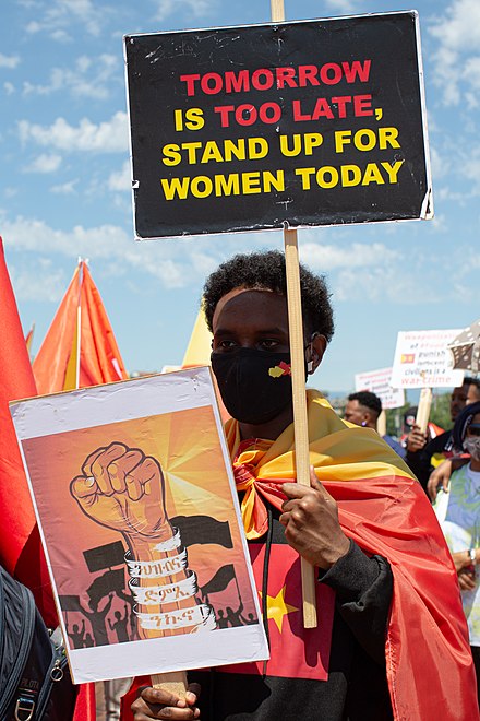 Protestor holding sign in support of women in Tigray