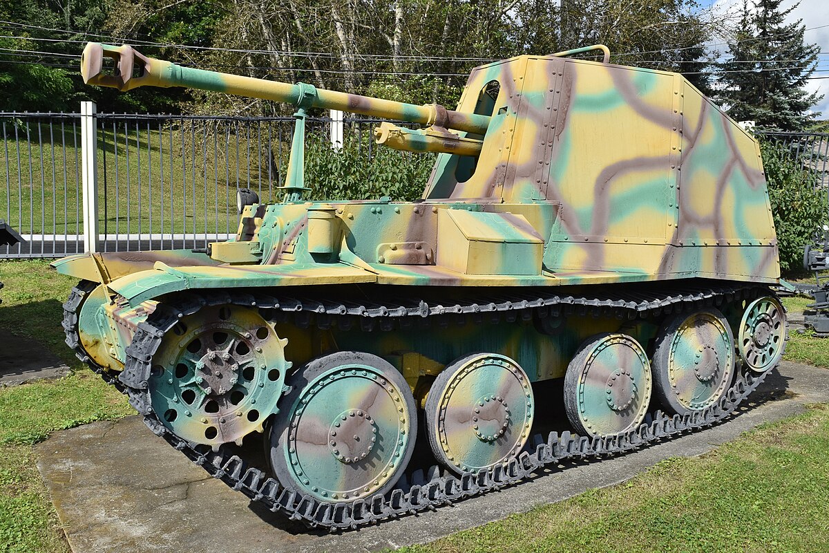 A German Marder tank destroyer drives past the Louis Vuitton store