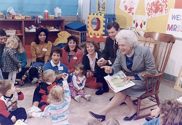 First Lady Barbara Bush, joined by Missouri governor John Ashcroft, with a "Parents as Teachers" group at the Greater St. Louis Ferguson-Florissant Sc