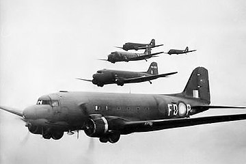 Five twin-engined cargo planes in flight