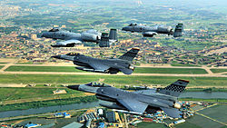 US Air Force F-16C Fighting Falcon and A-10A Thunderbolt II aircraft of the 51st Fighter Wing flying over Osan Air Base in June 2009.