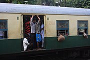 Passengers on a Kolkata local train at Hridaypur station en route from Barasat Junction.