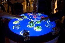 Reactable, an electronic musical instrument example of tangible user interface Reactable Multitouch.jpg