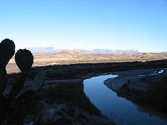The Rio Grande emerging from Santa Elena canyon with the Chisos mountains in the distance. The right bank is Mexico, the left the USA.