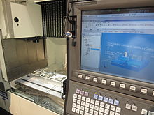STEP-NC machining on an Okuma CNC at IMTS 2014. STEP-NC at IMTS 2014.jpg