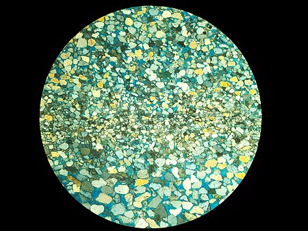 Thin Section of sandstone core as viewed through one of the CRC microscopes. Thin section of sandstone core as viewed through one of the USGS Core Research Center's microscopes.jpg