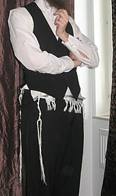 An Orthodox Jewish man wearing a wool tallit katan under his vest/waistcoat Tzitzskatan-ch.jpg