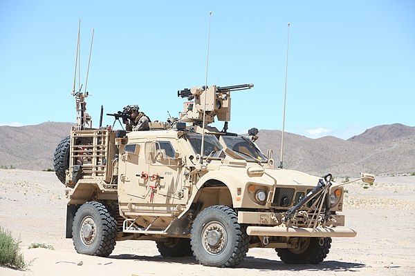 A Marine sniper with U.S. Marine Corps Forces, Special Operations Command, provides security from the back of an M-ATV during a medical engagement as 