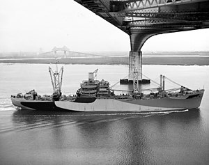 USS Stokes (AKA-68) passing under the Cooper River Bridge at Charleston, South Carolina (USA), circa in November 1944 (NH 108850).jpg