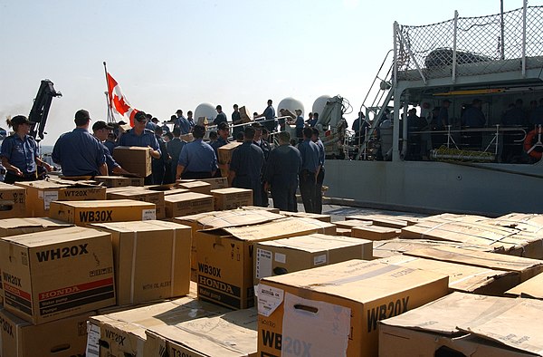 Sailors from HMCS Athabaskan unload supplies on a pier on board Naval Air Station Pensacola, Florida as part of Hurricane Katrina disaster relief effo