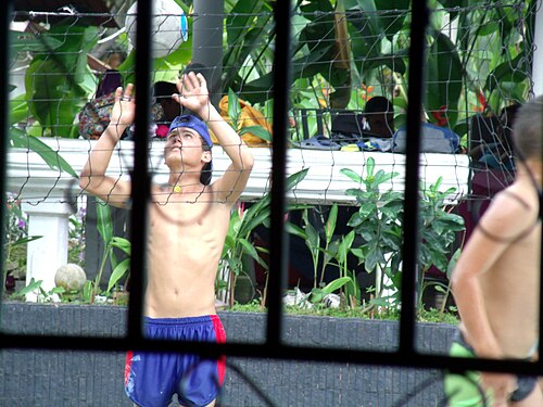 A young man playing volleyball.