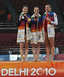 Mitchell (centre) at the 2010 Commonwealth Games medal ceremony for the uneven bars final. XIX Commonwealth Games-2010 Delhi Lauren Mitchell of Australia (Gold), Georgia Bonora of Australia (Silver) and Cynthia Lemieux Guillemette of Canada (Bronze).jpg