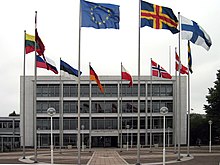 The Parliament of Aland with the flags of the European Union, Aland, Finland, Sweden, Denmark, Norway, Poland, Germany, Estonia, Russia, Lithuania, and Latvia. Alands lagting.jpg