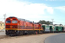 After decades of closures of the former South Australian Railways' intrastate routes, the last in broad gauge was the limestone service from Penrice quarry to Osborne, which ceased in 2014. Nine years before that, in 2005, a loaded train from Penrice is at Birkenhead, hauled by Australian Railroad Group broad-gauge locomotives 704 and 904. AdelaideRail 8.jpg