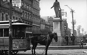 A mule-drawn streetcar at Lafayette Square along St. Charles Avenue in New Orleans in the early 1890s. The front apron of the streetcar displays an advertisement for a performance of Trovatore! at the French Opera House. CanalRobinsonsMuseumTram.jpg