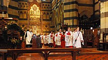 The choir in procession during a service at St Paul's Cathedral Carol Service at St Paul's (15973610958).jpg