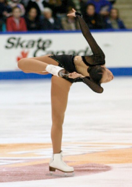 Arakawa performs a donut spin at the 2003 Skate Canada International in her free skate to Violin Fantasy on the opera Turandot.