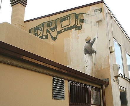 Self-referencial graffiti. The painter drawn on a wall erases his own graffiti, and may be erased himself by the next facade cleaner.