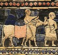 Detail of two men leading a bovid on the peace panels of the Standard of Ur.