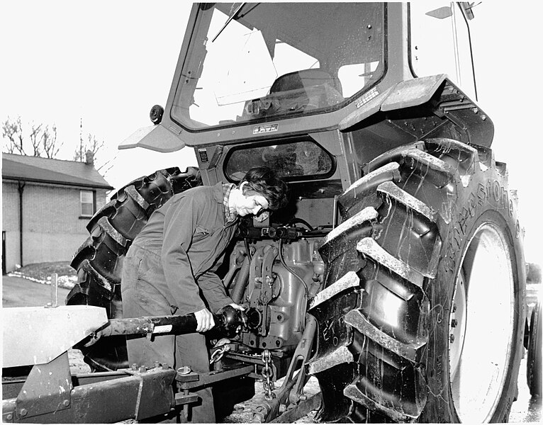 File:Farm wife working on a tractor (I0003230).jpg