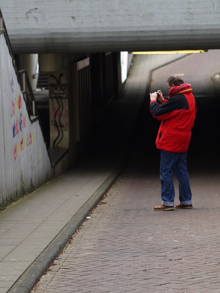 File:Fons Heijnsbroek is taking photos of graffiti street art under a concrete viaduct in Amsterdam, March 2012.tif
