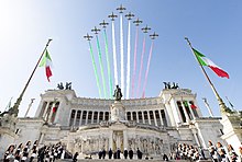 The Frecce Tricolori, with the smoke trail representing the national colours of Italy, above the Altare della Patria in Rome during the celebrations of the Festa della Repubblica in 2022 Frecce Tricolori 2022.jpg