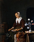 Woman feeding a cat label QS:Lfr,"Femme nourrissant un chat" label QS:Len,"Woman feeding a cat" label QS:Lpl,"Kobieta karmiąca kota" label QS:Lnl,"Vrouw die een kat voert" circa 1662-1665. oil on panelmedium QS:P186,Q296955;P186,Q106857709,P518,Q861259. 33.5 × 27 cm (13.1 × 10.6 in). Amsterdam, Rijksmuseum Amsterdam.