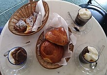 Coffee-almond flavored granita, served with a Sicilian brioche and a cornetto.