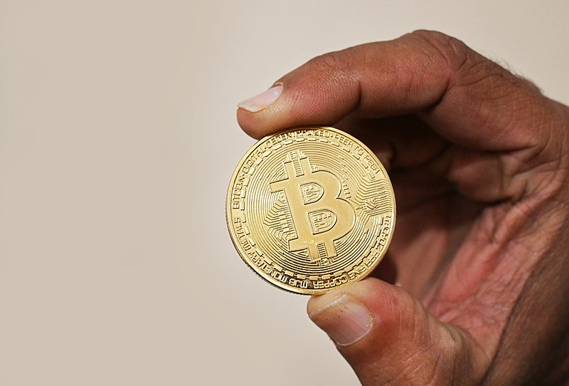 File:Holding Bitcoin cryptocurrency coin.jpg