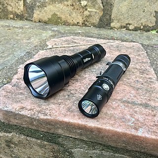 A flashlight is a portable hand-held electric light. The source of the light is usually an incandescent light bulb (lamp) or light-emitting diode (LED). A typical flashlight consists of the light source mounted in a reflector, a transparent cover to protect the light source and reflector, a battery, and a switch. These are supported and protected by a case.