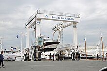 A small motor-boat lifted from the water by a travel lift at La Rochelle, France, 2016 Le yacht a moteur Liberte (4).JPG