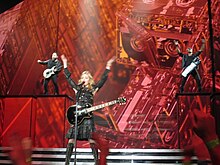 Madonna backed by her guitarists while performing the song on the MDNA Tour Madonna MDNA Tour "Turn Up the Radio" Houston.jpg