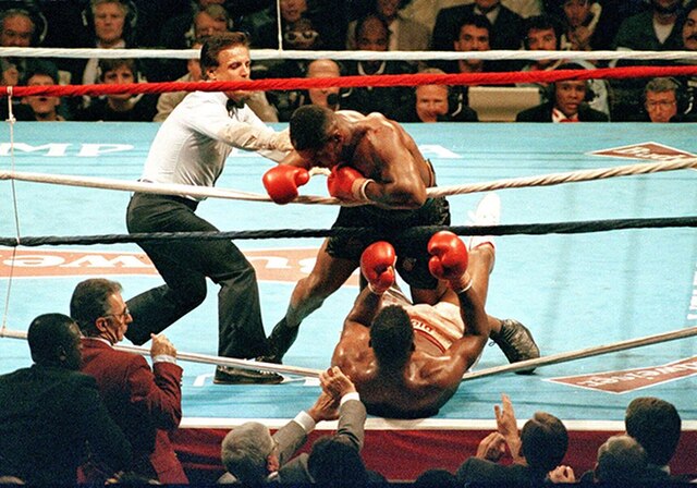 Mike Tyson knocks down Tyrell Biggs in the seventh round of their championship fight at Convention Hall in 1987