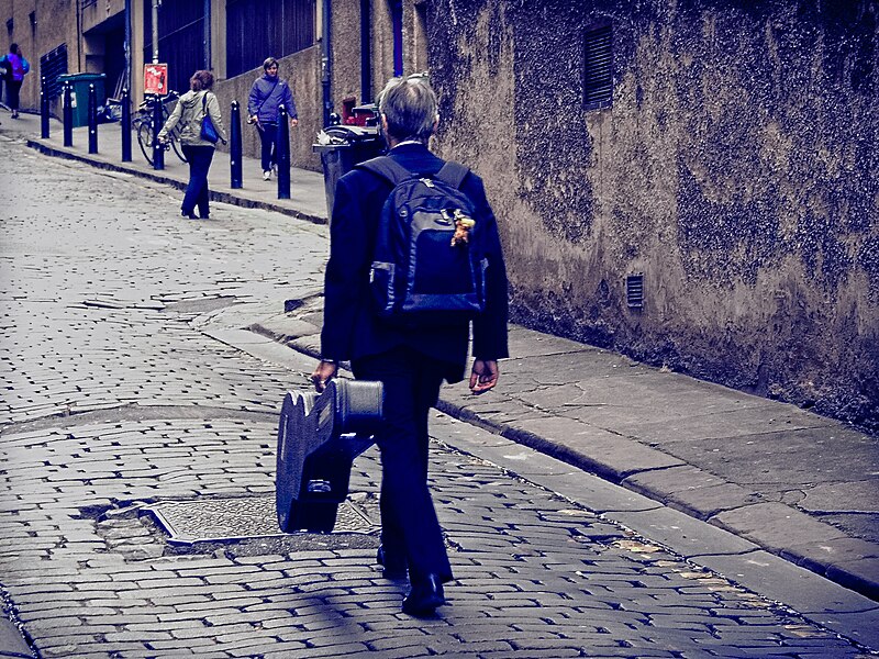 File:Musician walking up Niddry Street during the 2014 Festival.jpg