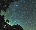 multicolored Perseid meteor striking the sky just to the right from Milky Way
