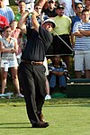 Phil Mickelson, who plays golf left-handed, following through after hitting a tee shot